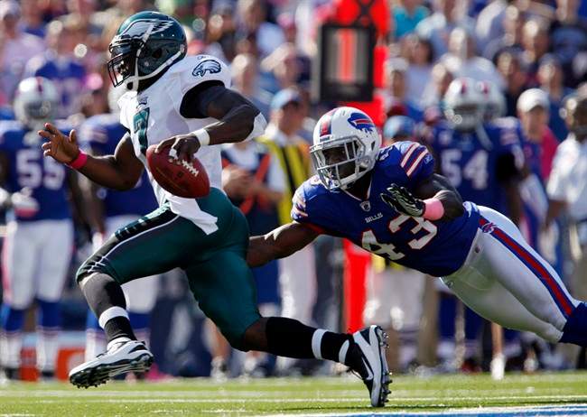 Philadelphia Eagles quarterback Michael Vick (7) runs past Buffalo Bills' Bryan Scott (43) during the first half of an NFL football game in Orchard Park, N.Y., Sunday, Oct. 9, 2011. (AP Photo/Derek Gee).