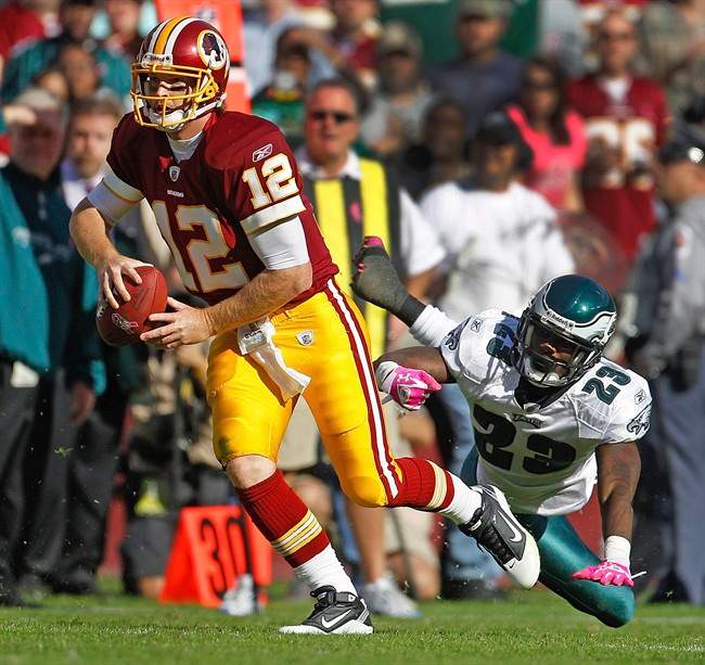 Washington Redskins quarterback John Beck (12) slips a tackle by Philadelphia Eagles defensive back Dominique Rodgers-Cromartie during the second half of an NFL football game in Landover, Md., Sunday, Oct. 16, 2011. The Eagles defeated the Redskins 20-13. (AP Photo/Evan Vucci).