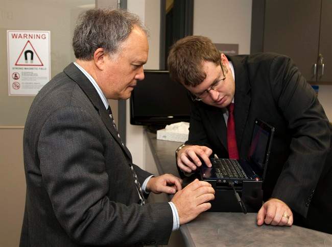 Christopher Barden, right, chief operating officer of Mindful Scientific, and Dr. Don Weaver, one of Canada's leading neuroscientists, display a prototype device that analyzes brain waves at the NRC Institute for Biodiagnostics in Halifax on Thursday, Oct. 6, 2011. The equipment analyzes brainwaves to determine if a person has a concussion after a fall or a hit to the head and there is hope that it will become a useful tool in reducing the number of brain injuries in all levels of sport.THE CANADIAN PRESS/Andrew Vaughan.