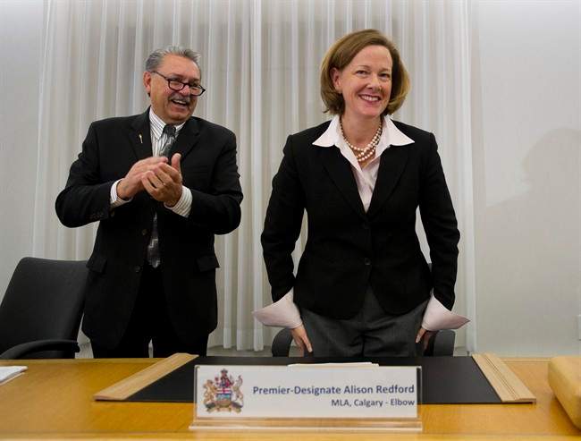 Allison Redford attends her first caucus meeting as Alberta premier-designate at Government House in Edmonton, Alberta on Tuesday, Oct. 4, 2011 as Health Minister Gene Zwosdesky applauds. THE CANADIAN PRESS/ Ian Jackson.