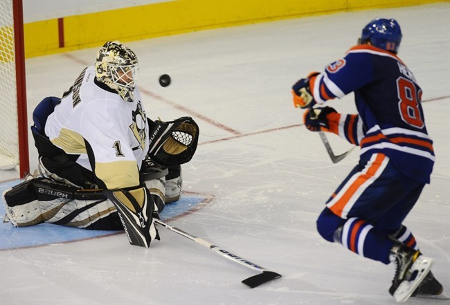 Edmonton Oilers' Ales Hemsky, 83, scores on Pittsburgh Penguins goalie Brent Johnson during the shoot out NHL hockey action in Edmonton, on Sunday, October 9, 2011. 