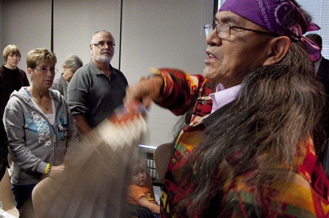 Rick Frey, centre, father of Robert Pickton murder victim Marnie Frey, and stepmother Lynn Elder, left, look on as Elder Eugene Harry of the Squamish Nation performs a ceremonial blessing at the start of the missing women inquiry in downtown Vancouver, Tuesday, Oct. 11, 2011.Commissioner Wally Oppal has opened hearings to examine why police failed to stop Robert Pickton as he murdered impoverished sex workers from Vancouver's Downtown Eastside. THE CANADIAN PRESS/Jonathan Hayward.