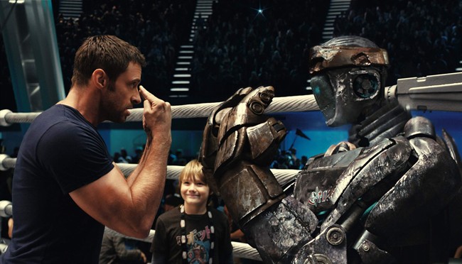 FILE - This file image provided by Disney/DreamWorks II shows Hugh Jackman, left, and Dakota Goyo in a scene from "Real Steel." The film is set in the near-future when robot fighters have replaced humans in the ring. The film debuted at No. 1 with $27.3 million. The "Real Steel" added $22.1 million in 19 overseas markets for a worldwide total of $49.4 million. (AP Photo/Disney/DreamWorks II, File).