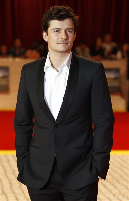British actor Orlando Bloom arrives for the UK premiere of The Three Musketeers in 3D, at a cinema in west London, Tuesday, Oct. 4, 2011. (AP Photo/Joel Ryan).