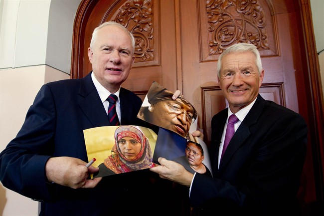 Norwegian Nobel Committee chairman Thorbjoern Jagland, right, and Permanent Secretary Geir Lundestad, left, hold up photographs of Liberian President Ellen Johnson Sirleaf, center top, Liberian peace activist Leymah Gbowee, center right, and Tawakkul Karman of Yemen, center left, after announcing them as the recipients of the 2011 Nobel Peace prize in Oslo, Norway, Friday, Oct. 7, 2011. The 2011 Nobel Peace Prize was awarded Friday to Liberian President Ellen Johnson Sirleaf, Liberian peace activist Leymah Gbowee and Tawakkul Karman of Yemen for their work on women's rights. (AP Photo/Scanpix Norway, Terje Bendiksby) NORWAY OUT.