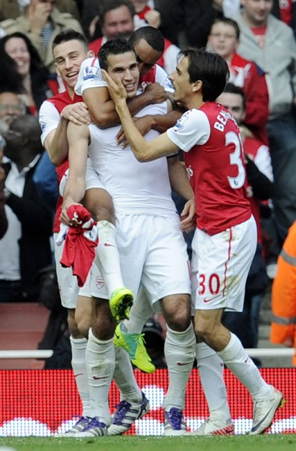 Arsenal's Robin van Persie, 2nd left, celebrates with teammates Theo Walcott, 2nd right, Laurent Koscielny, left, and Yossi Benayoun after scoring a goal against Sunderland during their English Premier League soccer match at the Emirates stadium, London, Sunday, Oct. 16, 2011. (AP Photo/Tom Hevezi).