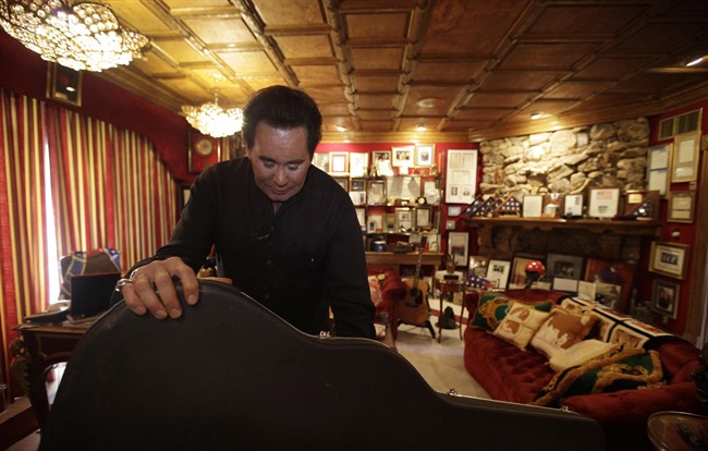 FILE - In this Friday, Nov. 12, 2010 file photo, Wayne Newton shows some of the memorabilia in the Red Room during an interview at his home in Las Vegas. Newton said Tuesday Oct. 18, 2011 plans to open his sprawling Casa de Shenandoah estate in Las Vegas for public tours are almost complete. (AP Photo/Julie Jacobson).