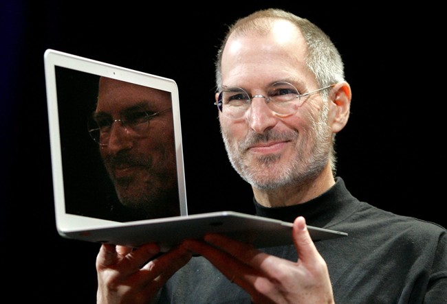 FILE - In this Jan. 15, 2008, file photo, Apple CEO Steve Jobs holds up the new MacBook Air after giving the keynote address at the Apple MacWorld Conference in San Francisco. Apple on Wednesday, Oct. 5, 2011 said Jobs has died. He was 56. (AP Photo/Jeff Chiu, File).