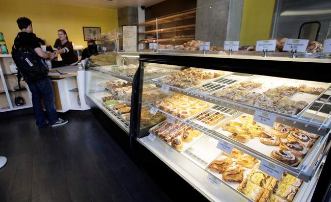 This Aug. 18, 2011 photo shows customers and employees in the Hygge Bakery in Los Angeles. At Hygge, a large glass display case boasts dozens of pastries ranging from kringle bars _ square and crisp, also popular in Norway _ to round vanilla-, raspberry- and apple-filled spandauer (“span-dow-uh”). (AP Photo/Nick Ut).