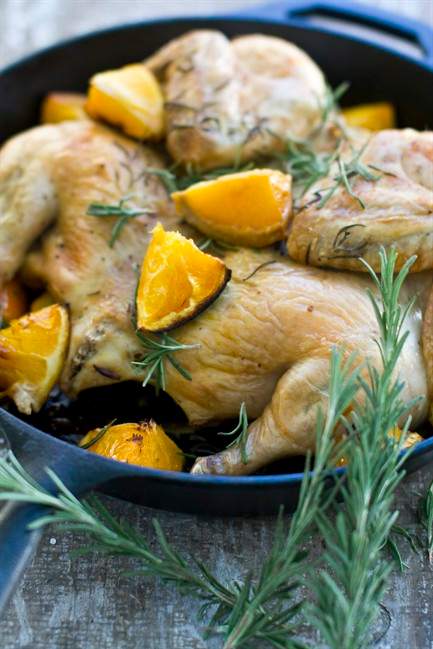 This Sept. 28, 2011 photo shows orange-rosemary spatchcocked chicken in Concord, N.H. To spatchcock a chicken _ or any bird _ you simply cut along the center backbone, starting at the neck and right through to the rump. (AP Photo/Matthew Mead).