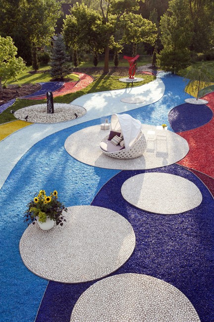 This undated photo courtesy of Nathan Harmon Photography shows Michele Semin's yard at her home in Lincoln, Neb. Her friend, designer Chris Murphy, created the outdoor design using colored glass. (AP Photo/Nathan Harmon Photography, Nathan Harmon).