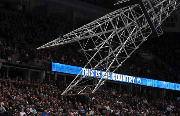 Derrick dangles over ice during Monday night Oilers game - image