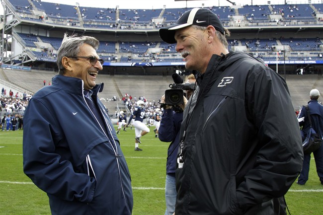 Penn State head coach Joe Paterno, left, talks with Purdue head coach Danny Hope during warm ups before an NCAA college football game in State College, Pa., Saturday, Oct. 15, 2011. (AP Photo/Gene J. Puskar).