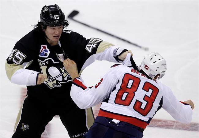 Pittsburgh Penguins' Arron Asham, left, and Washington Capitals' Jay Beagle (83) fight during the third-period of an NHL hockey game in Pittsburgh Thursday, Oct. 13, 2011. Beagle left the game bleeding from the face and the Capitals won in overtime 3-2. (AP Photo/Gene J. Puskar).