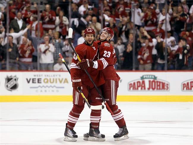 Phoenix Coyotes defenseman Oliver Ekman-Larsson, right, of Sweden, celebrates his second goal of the game with teammate Adrian Aucoin, left, in the second period of an NHL hockey game against the Winnipeg Jets Saturday, Oct. 15, 2011, in Glendale, Ariz. (AP Photo/Paul Connors).