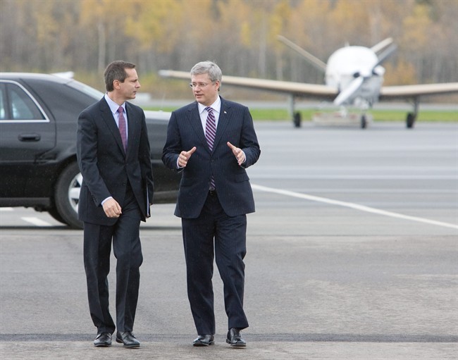 Prime Minister Stephen Harper talks with Ontario Premier Dalton McGuinty during a visit to the Peterborough Municipal Airport in Peterborough, Ont., on Friday, Oct. 14, 2011. Harper and McGuinty were at the airport to mark the completion of the airport expansion, partially funded by the federal and provincial governments, and a move which will see an increase in local employment as well as boosting the aviation facilities there. THE CANADIAN PRESS/Peter Redman.