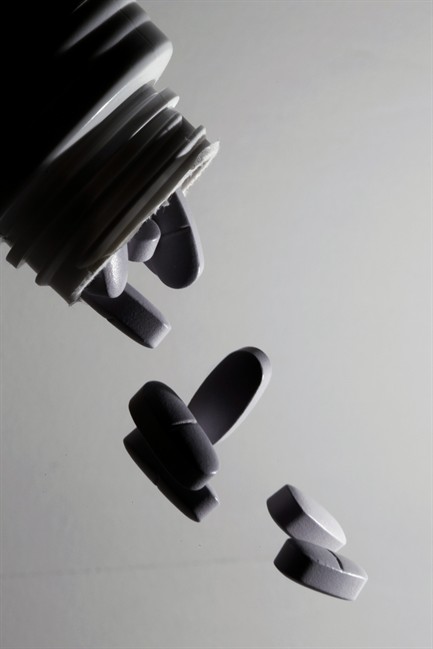 In this Thursday, Oct. 13, 2011 photo illustration, multivitamins are poured from a bottle in Philadelphia. Two studies released in Oct. 2011 raised gnawing worries about the safety of vitamin supplements and a host of questions. Vitamins have long had a "health halo" - many people think they won't hurt and at worst might be unnecessary. The industry calls them an insurance policy against bad eating. But our foods increasingly are pumped full of them - even junk foods and drinks often are fortified with nutrients to give them a healthier profile - so the risk is rising that we're getting too much. Add a supplement and you may exceed the upper limit. (AP Photo/Matt Rourke).