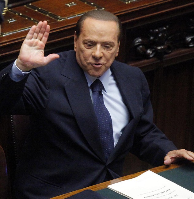 Former Italian Premier Silvio Berlusconi gestures in the Lower Chamber, in Rome, Friday, Oct. 14, 2011.