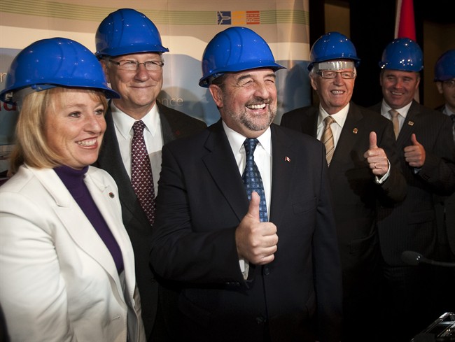 Federal Transport Minister Denis Lebel, center, poses with Longueuil Mayor Caroline St-Hilaire, left, Montreal Mayor Gerald Tremblay, 2nd left, and other dignitaries at a news conference to announce plans for a new bridge to replace the Champlain Bridge, on Wednesday, October 5, 2011 in Montreal. THE CANADIAN PRESS/Ryan Remiorz.