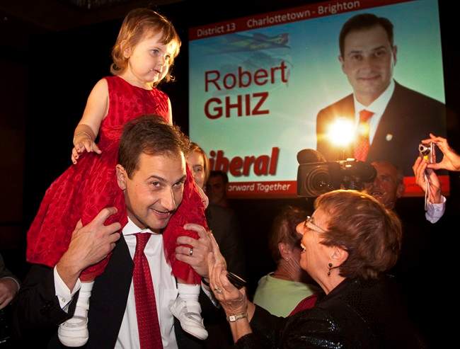 Prince Edward Island Premier Robert Ghiz carries his two-year-old daughter Julia as he greets supporters in Charlottetown on Monday, Oct. 3, 2011. Ghiz's Liberal party won a majority in the provincial election. THE CANADIAN PRESS/Andrew Vaughan.