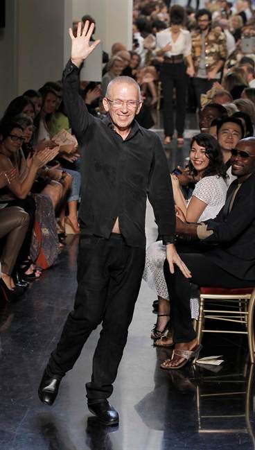 French Designer Jean Paul Gaultier waves at the end of the fashion house's spring-summer 2012 ready to wear collection presented Saturday, Oct. 1, 2011, in Paris. (AP Photo/Jacques Brinon).