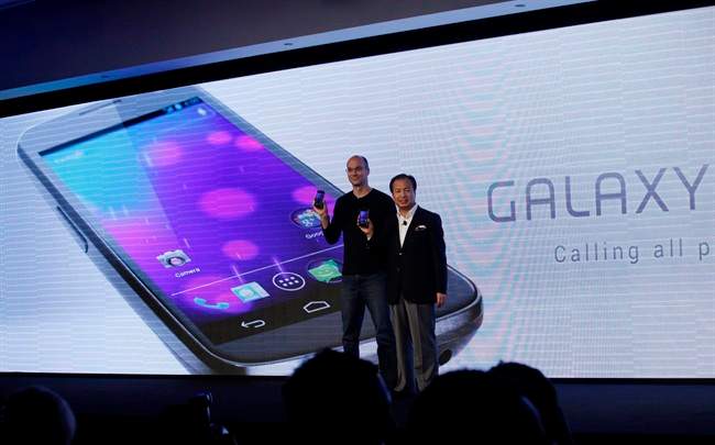 Google's top mobile executive Andy Rubin, left and J.K. Shin, president and head of mobile communications business from Samsung, hold the new Galaxy Nexus smartphone during the news conference in Hong Kong Wednesday, Oct. 19, 2011. South Korea's Samsung Electronics Co. Ltd on Wednesday unveiled its Galaxy Nexus smartphone, the first to use the latest version of Google's Android operating system. 