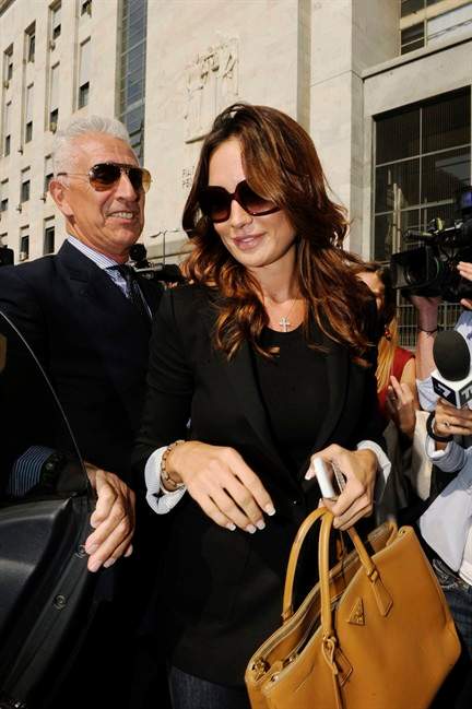 Nicole Minetti, a Lombardy regional official who was formerly Italian Prime Minister Silvio Berlusconi's dental hygienist, leaves a Milan court, Italy, Monday, Oct.3, 2011. Minetti, according to prosecutors' documents, recruited "a significant number of young women, who prostituted themselves with Silvio Berlusconi." Minetti, who is also under investigation, denies the accusations. Berlusconi is on trial from April 6, 2011 in Milan on charges of paying for sex with Karima el Mahroub, nicknamed Ruby, a 17-year-old Moroccan gilr. Berlusconi has been in court for a number of business-related charges, but this is the first time the 75-year-old billionaire businessman is being tried for personal conduct. (AP Photo/Luca Bruno).