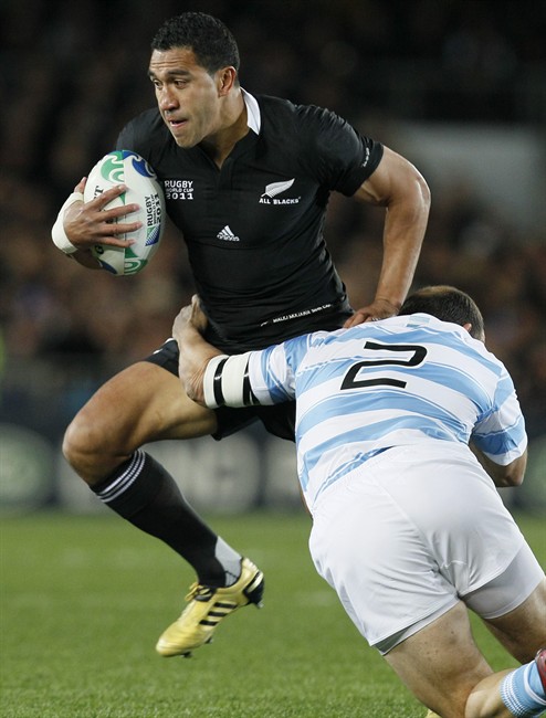 New Zealand All Blacks Mils Muliaina runs through a tackle by Argentina's Mario Ledesma Arocena during their Rugby World Cup quarterfinal match at Eden Park, Auckland, New Zealand, Sunday, Oct. 9, 2011. (AP Photo/Alastair Grant).