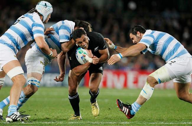 New Zealand All Blacks Mils Muliaina attempts to break through the tackles of Argentina defenders during their Rugby World Cup quarterfinal match at Eden Park, Auckland, New Zealand, Sunday, Oct. 9, 2011. (AP Photo/Alastair Grant).