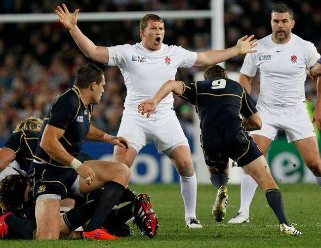 England's Dylan Hartley reacts as Scotland's Mike Blair runs at him during their Rugby World Cup game at Eden Park stadium in Auckland, New Zealand, Saturday, Oct. 1, 2011. (AP Photo/Alastair Grant).