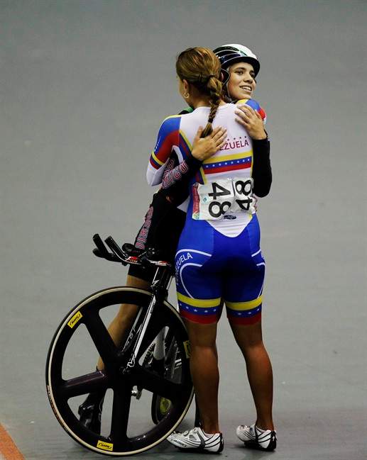 Venezuela's Angie Gonzalez, back to the camera, embraces Mexico's Sofia Arreola after the cycling women's omnium 500m time trial final at the Pan American Games in Guadalajara, Mexico, Thursday, Oct. 20, 2011. Gonzalez won gold and Arreola silver. (AP Photo/Ricardo Mazalan).