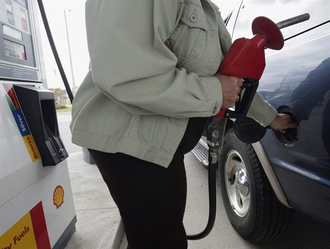 A customer fills her full-size sport-utility vehicle at a Shell station in Mississauga, Ont.