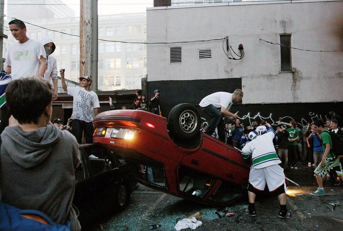 People flip a vehicle on June 15, 2011 in Vancouver, Canada. Vancouver broke out in riots after their hockey team the Vancouver Canucks lost in Game Seven of the Stanley Cup Finals.  