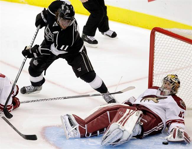 Phoenix Coyotes goalie Mike Smith, right, stops a shot as Los Angeles Kings center Anze Kopitar, of Slovenia, watches during the second period of Game 4 of the NHL hockey Stanley Cup Western Conference finals in Los Angeles, Sunday, May 20, 2012. (AP Photo/Jae C. Hong).