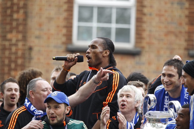 Chelsea player Didier Drogba celebrate winning the Champions League during a parade in London, Sunday, May 20, 2012. Drogba scored the decisive penalty in the shootout as Chelsea beat Bayern Munich to win the Champions League final in Munich, Germany after a dramatic 1-1 draw on Saturday, May 19. (AP Photo/Lefteris Pitarakis).