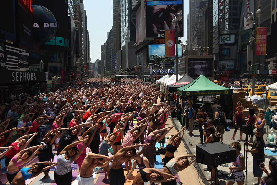 People do Bikram Yoga outside. 