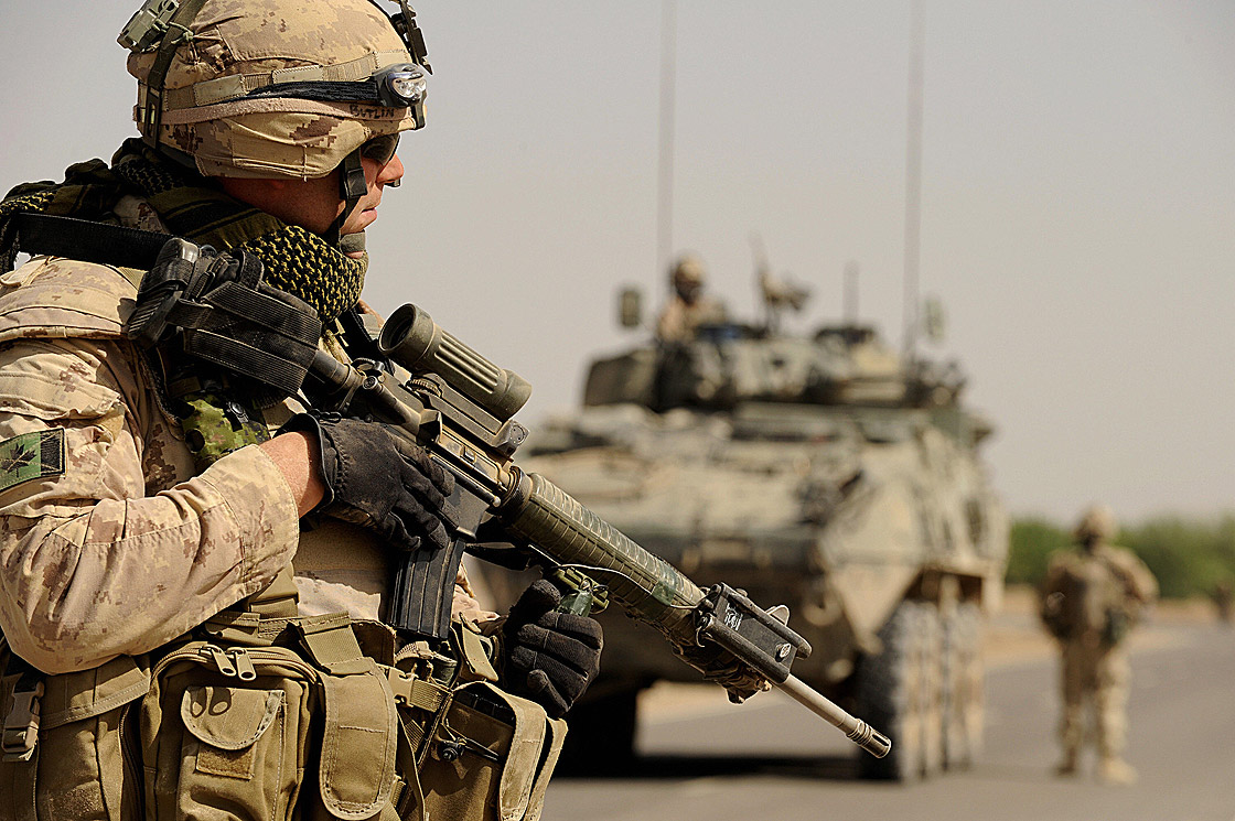 Canadian soldiers with the NATO-led International Security Assistance Force (ISAF) walk during a patrol in Panjwayi district 30 km in the west of Kandahar province on March 28, 2008.