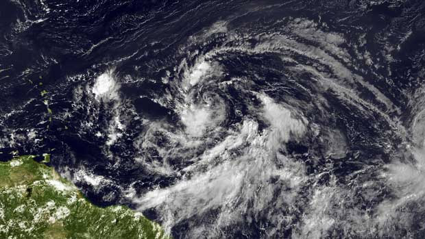 In this handout satellite image provided by National Oceanic and Atmospheric Administration (NOAA);an area of low pressure located about 1000 miles east of the Lesser Antilles moves westward at 20 to 25 mph on August 20, 2012 in the Atlantic Ocean.