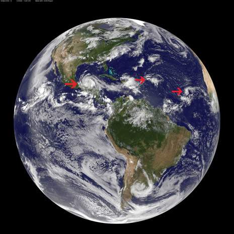 Three storms in the Atlantic Ocean basin have caught forecasters attention at the U.S. National Hurricane Center. They were captured in one image from NOAA's GOES-13 satellite on 8 August. To the west lies Tropical Storm Ernesto (on left), currently moving over Mexico. The second area forecasters are eyeing is that of post-tropical storm Florence's remains (in middle), located about 450 miles east of the Northern Leeward Islands. Farthest east (on right) lies a low pressure area associated with a tropical wave in the eastern Atlantic.
