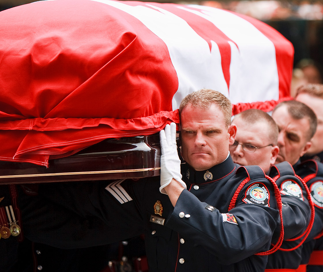 A Police honor guard carry the coffin of Canadian opposition leader Jack Layton, following a state funeral in Toronto, Ontario on August 27, 2011.