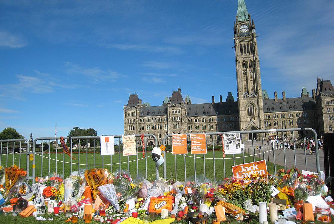 Flowers are left in tribute for former Canadian opposition leader Jack Layton in front of the Parliament building on August 23, 2011 in Ottawa, Ontario.