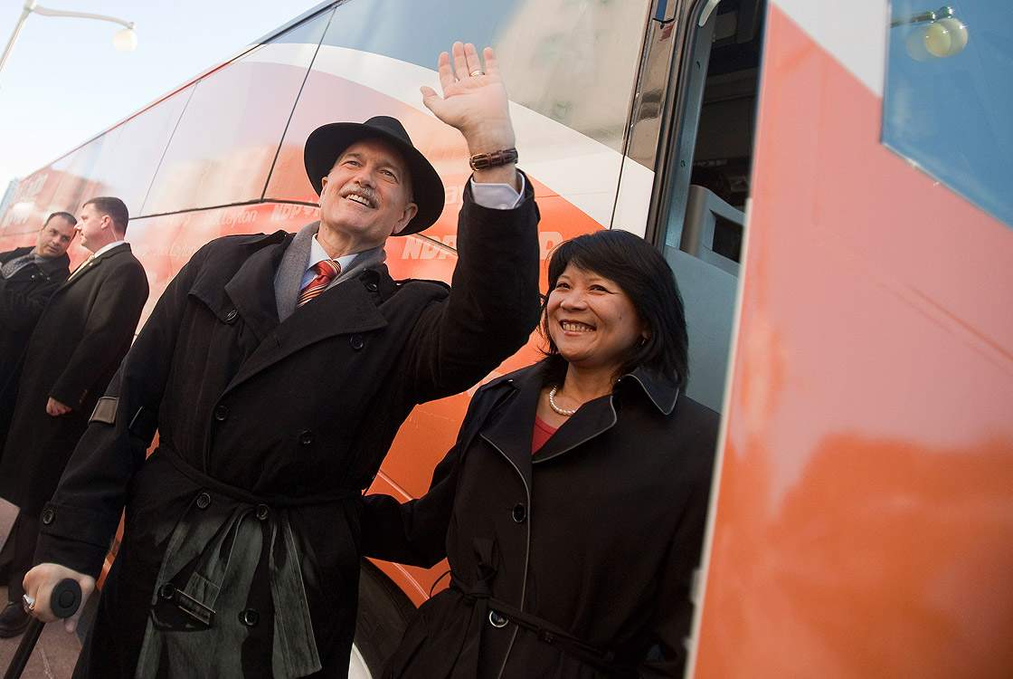 New Democratic Party (NDP) leader Jack Layton waves to the crowd as he boards the bus with his wife, NDP Member of Parliament Olivia Chow, following the NDP's campaign kickoff event at the Chateau Laurier in Ottawa, Canada, on March 26, 2011 one day after the fall of the Conservative government.