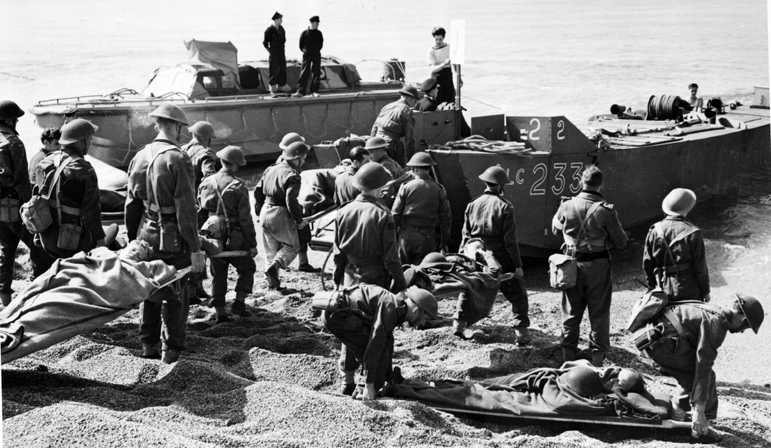 Members of the Royal Canadian Medical Corps evacuating Allied soldiers from the beach after the Dieppe, France raid during the Second World War.