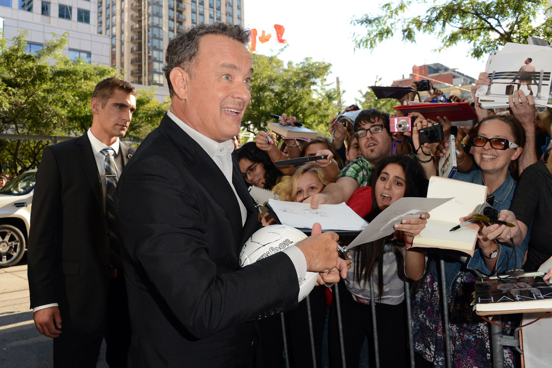 Actor Tom Hanks signs autographs at the 'Cloud Atlas' premiere during the 2012 Toronto International Film festival at the Princess of Wales Theatre on September 8, 2012 in Toronto.