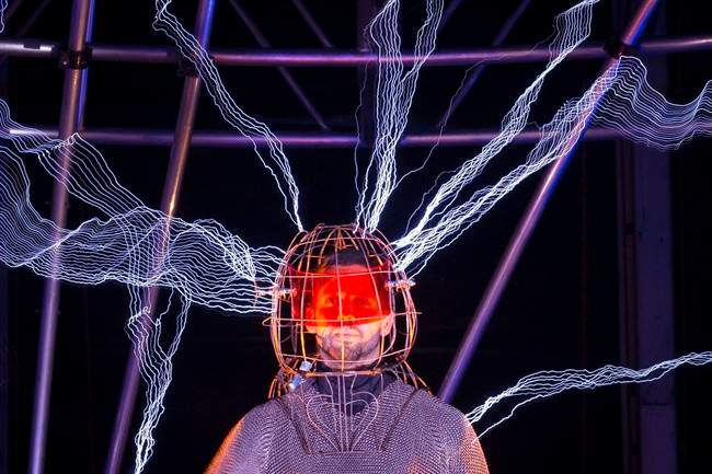 Magician David Blaine stands inside an apparatus surrounded by a million volts of electric currents streamed by tesla coils during his 72-hour "Electrified: 1 Million Volts Always On" stunt on Pier 54, Friday, Oct. 5, 2012, in New York. The stunt, sponsored by Intel, is the latest of daredevil endeavors by the magician whose previous stunts included being encased in ice for over 60 hours in Times Square. (AP Photo/John Minchillo).