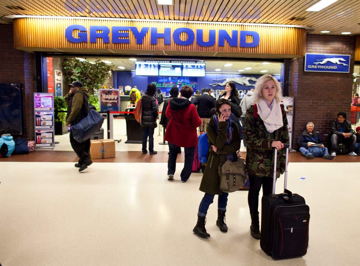People make their way outside of a Greyhound Lines ticket office.