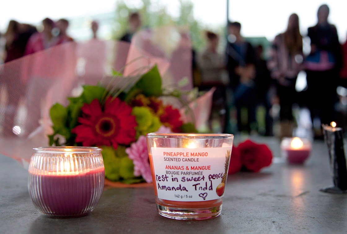 Flowers and candles are seen as people gather at a memorial honoring teen Amanda Todd in Maple Ridge, B.C., Monday, Oct. 15, 2012. Todd who was a victim of bullying took her own life. 