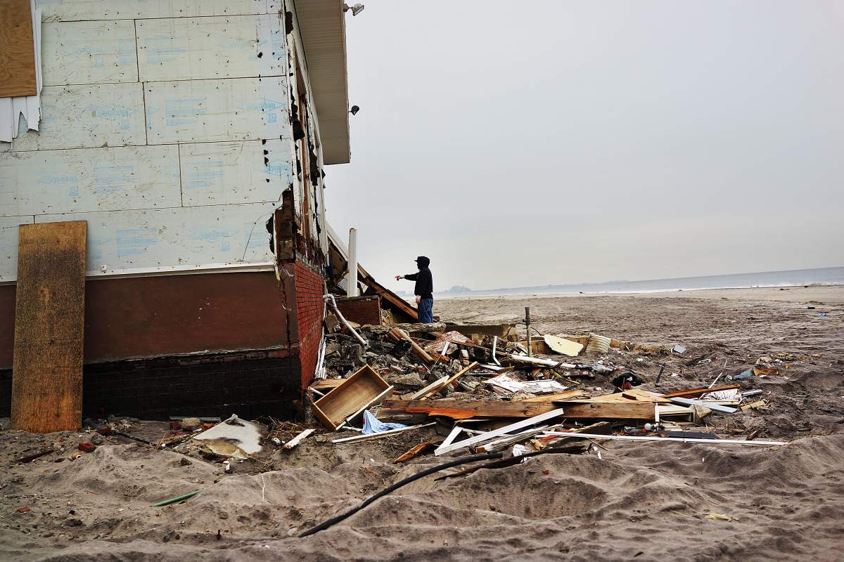 Contractor Rene Huerta looks at a damaged home he had been helping to remodel before Hurricane Sandy .