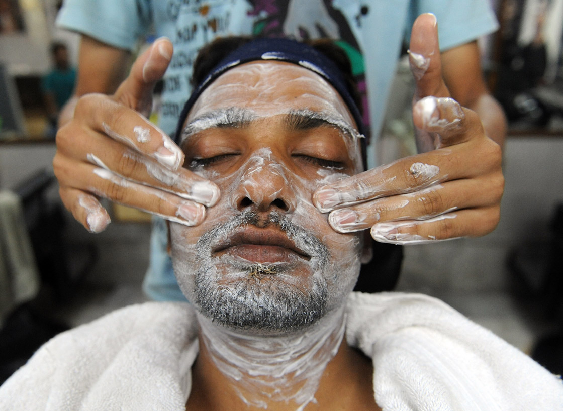 A man has a facial massage at a men's beauty salon in New Delhi on July 15, 2010.