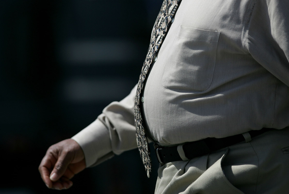 Overweight man walking down the street